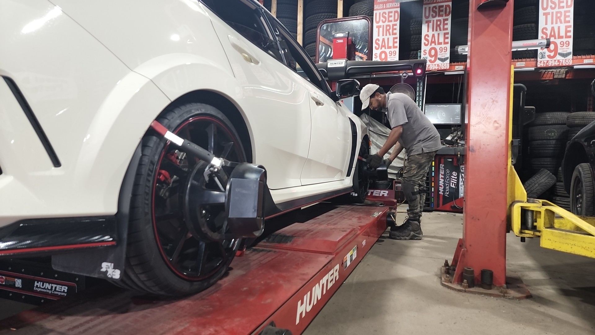 Mechanic at work in the alignment bay at Ammar Auto